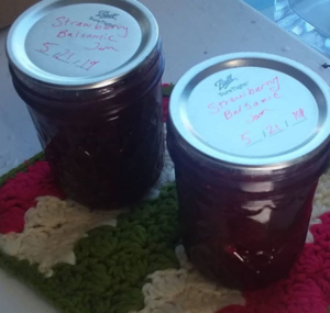 Two jars of jam on a potholder