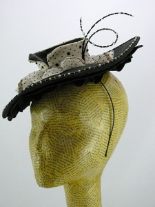 A wide brimmed cocktail hat with ruffles, inspired by Dior's "New Look." 